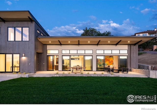 back of house featuring a patio and a yard