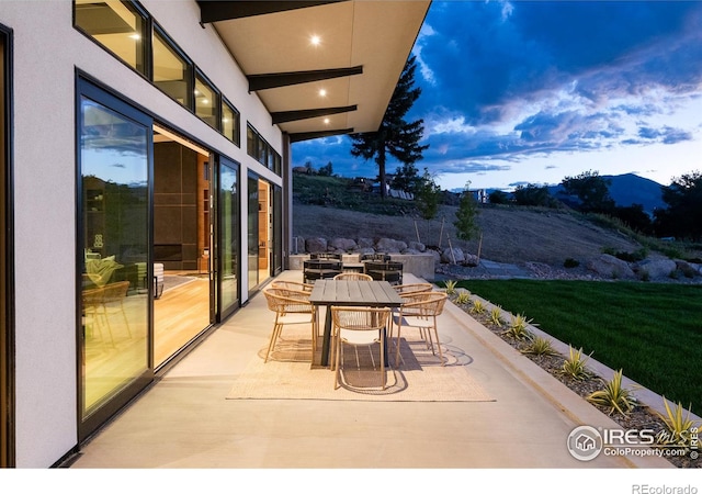 patio terrace at dusk with a mountain view