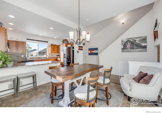 dining room featuring sink and a notable chandelier