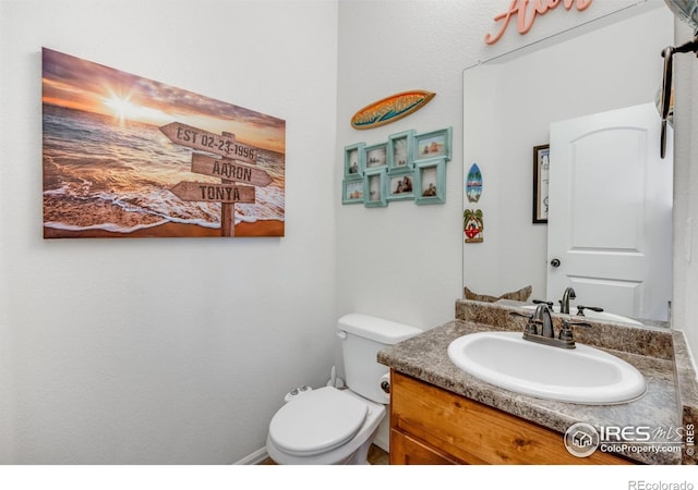 bathroom with toilet and vanity