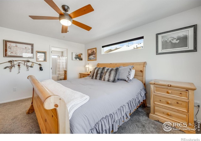 bedroom with ceiling fan, dark colored carpet, and ensuite bathroom