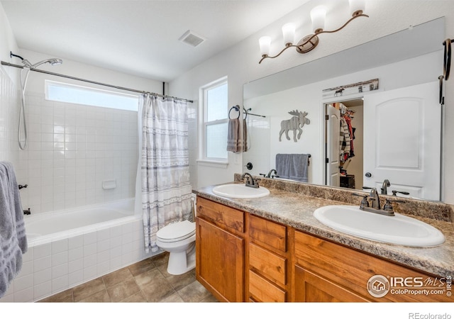 full bathroom with vanity, toilet, and shower / bath combo