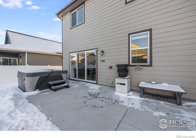 back of house with a hot tub