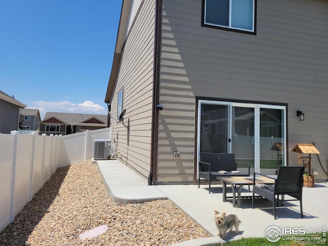 rear view of property featuring a patio and cooling unit