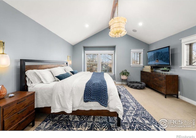 carpeted bedroom with lofted ceiling