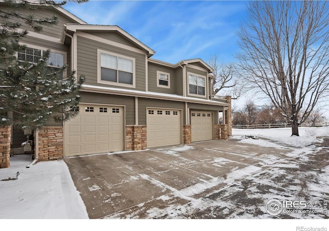 view of snow covered exterior featuring a garage