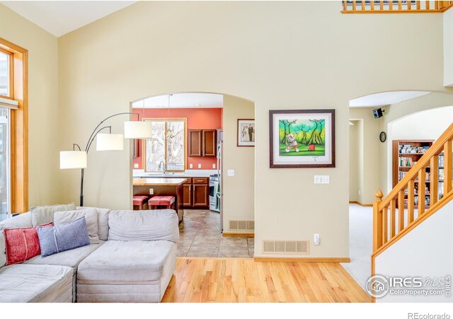 living room with sink and light hardwood / wood-style floors