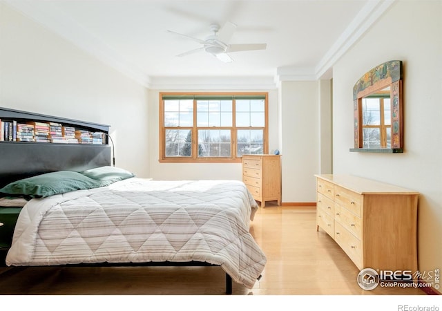 bedroom with light hardwood / wood-style flooring, ceiling fan, and ornamental molding