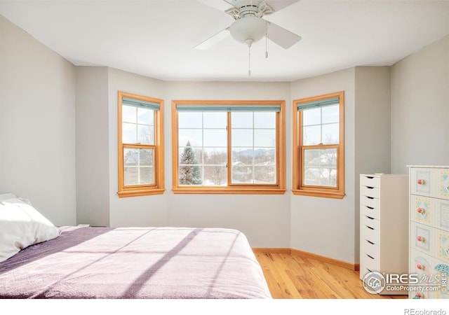 bedroom with ceiling fan and light wood-type flooring