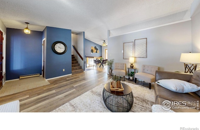 living room with a baseboard heating unit, hardwood / wood-style flooring, a textured ceiling, and ceiling fan