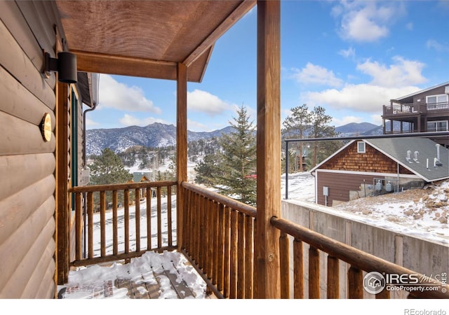 snow covered deck featuring a mountain view