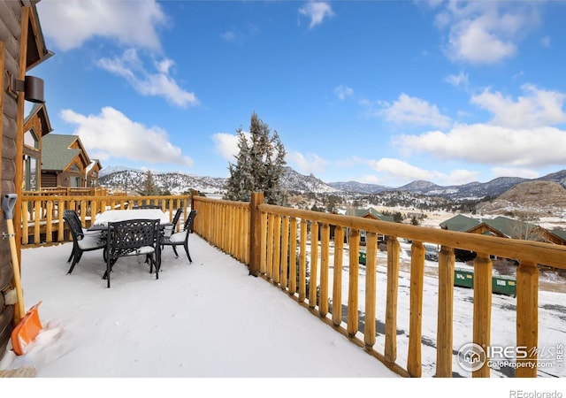 snow covered deck featuring a mountain view