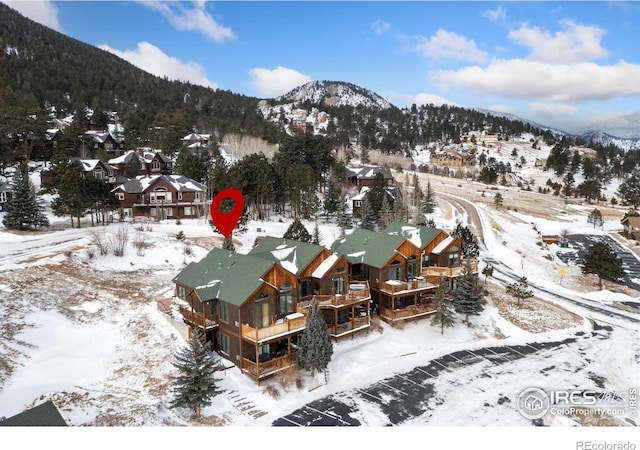 snowy aerial view featuring a mountain view