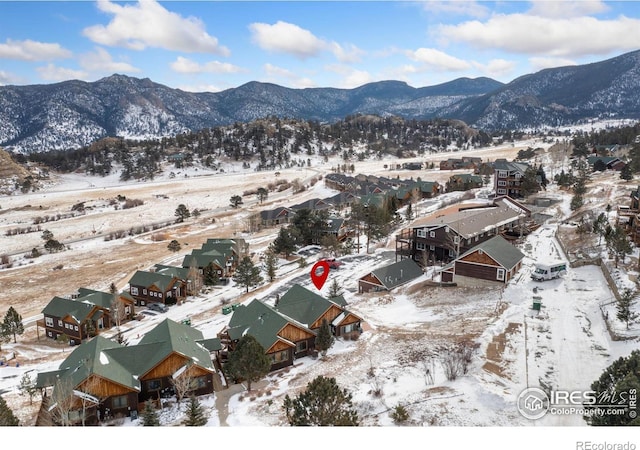 snowy aerial view with a mountain view