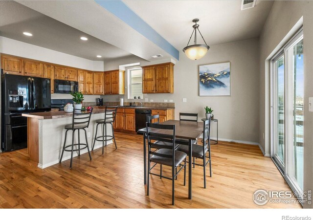 dining area featuring sink and light wood-type flooring