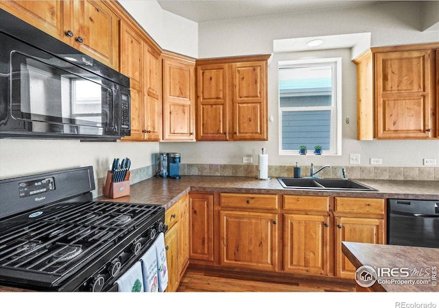 kitchen with sink and black appliances