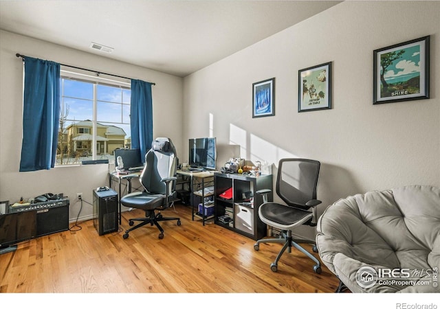 home office with wood-type flooring