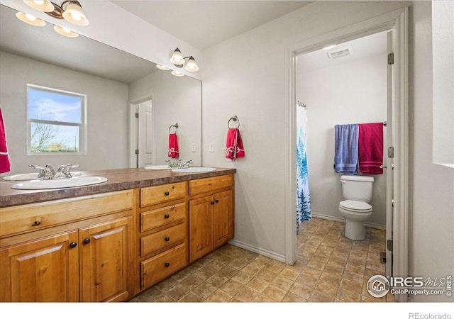 bathroom with vanity and toilet