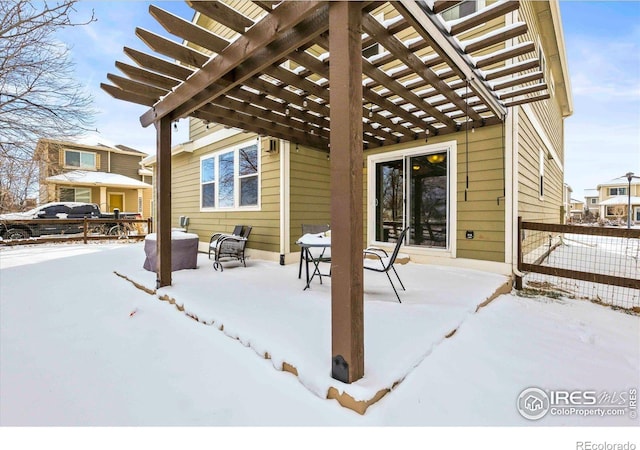 snow covered patio with a pergola