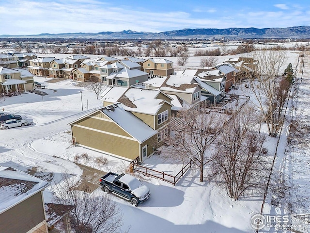 snowy aerial view featuring a mountain view