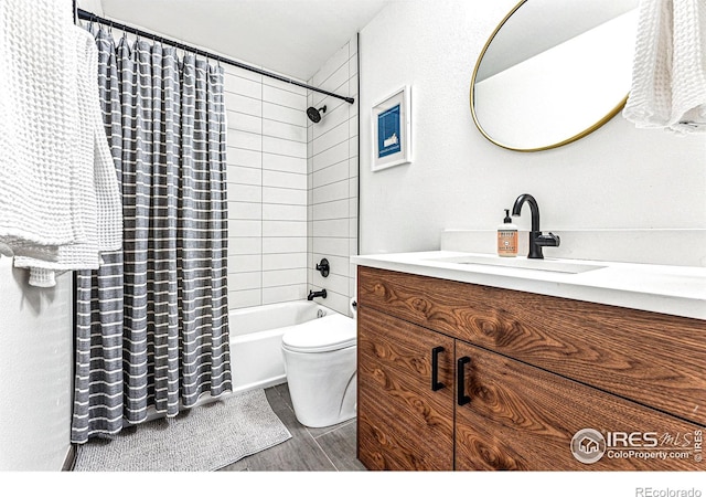 full bathroom with hardwood / wood-style flooring, vanity, toilet, and shower / bath combo with shower curtain