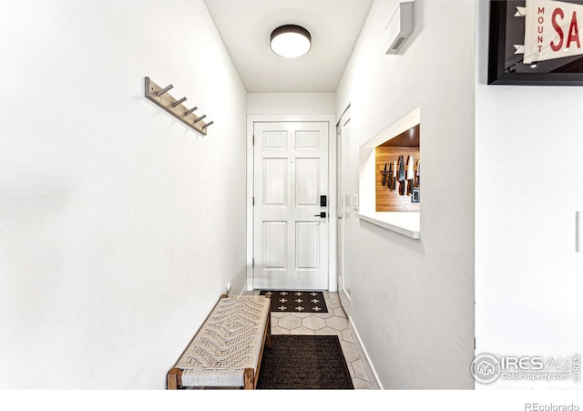 doorway to outside with tile patterned flooring