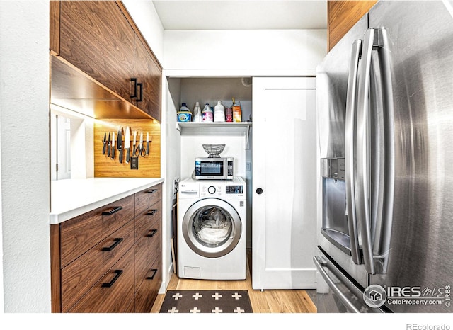 clothes washing area with washer / dryer