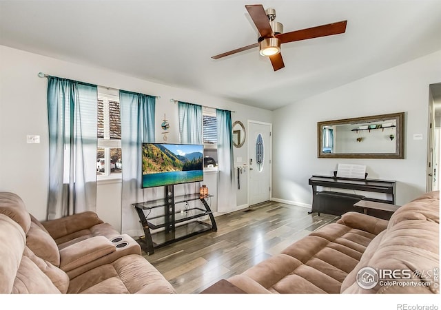 living room featuring wood-type flooring, vaulted ceiling, and ceiling fan