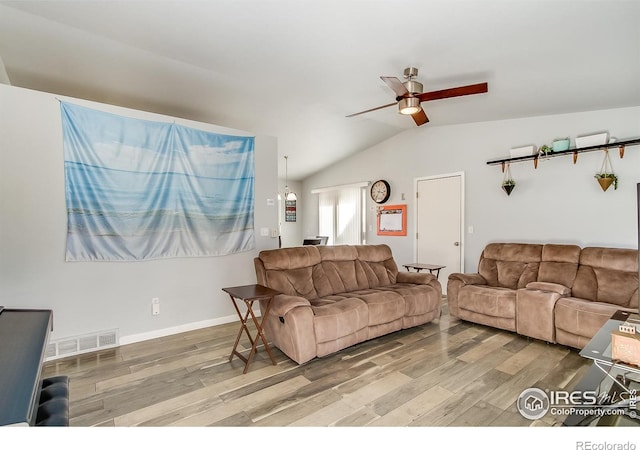 living room with vaulted ceiling, hardwood / wood-style floors, and ceiling fan