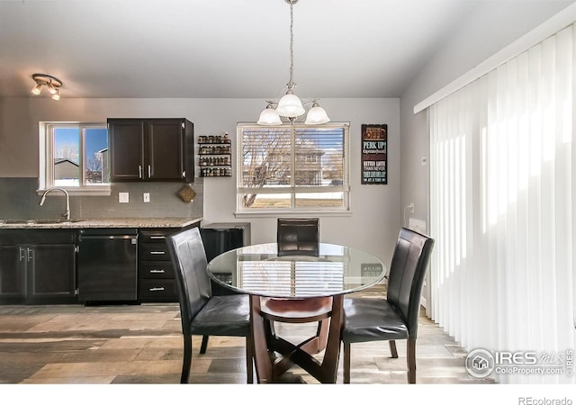 dining space with sink and light wood-type flooring