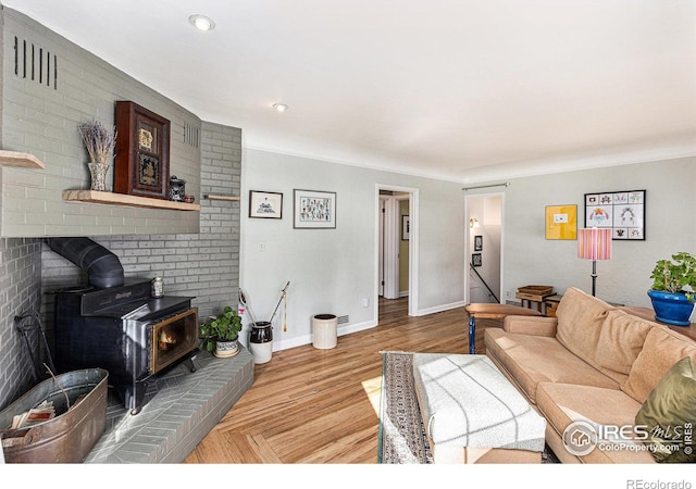 living room featuring ornamental molding and a wood stove