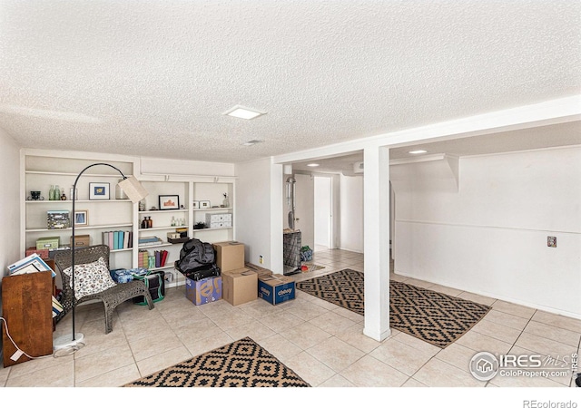 interior space with light tile patterned flooring and a textured ceiling