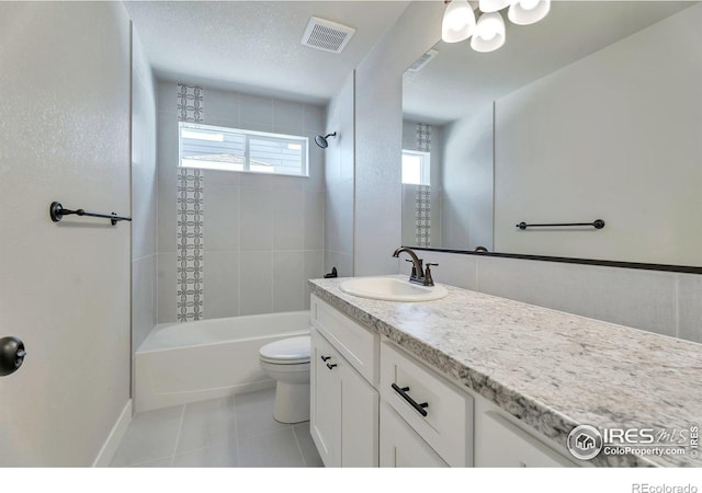 full bathroom featuring tiled shower / bath combo, vanity, tile patterned floors, and toilet