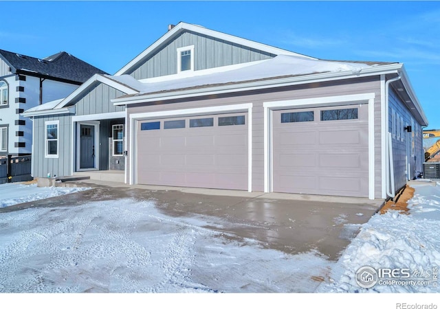 view of front of house featuring a garage and central AC