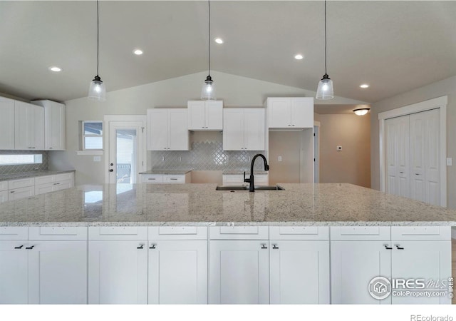 kitchen featuring sink and white cabinets