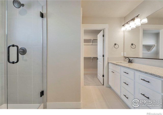 bathroom with vanity, tile patterned floors, and a shower with shower door