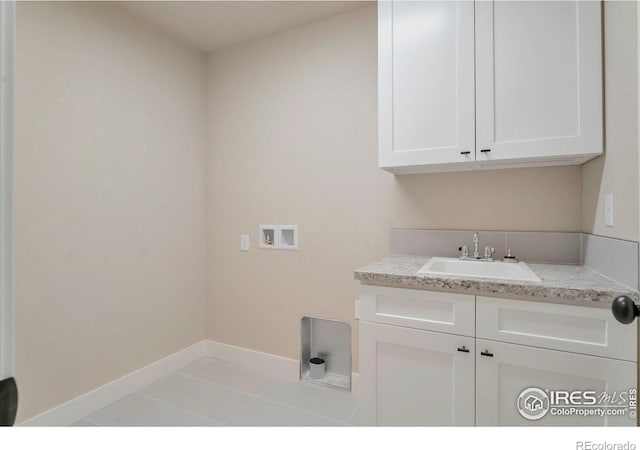 laundry room featuring cabinets, hookup for a washing machine, sink, and light tile patterned floors