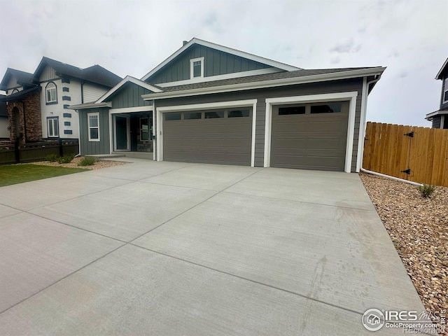 5753 Pintail Way, Frederick, CO 80504 - view of front of house featuring board and batten siding, a garage, and driveway
