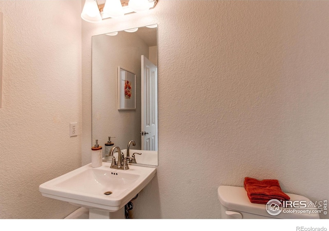 bathroom with sink and toilet