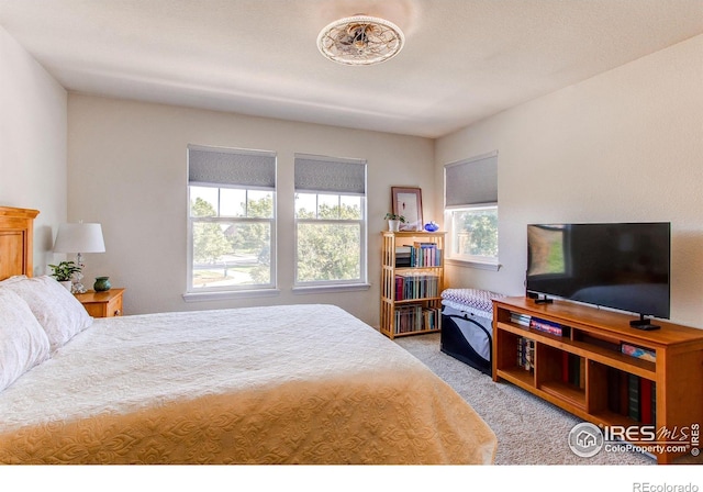 bedroom featuring light colored carpet