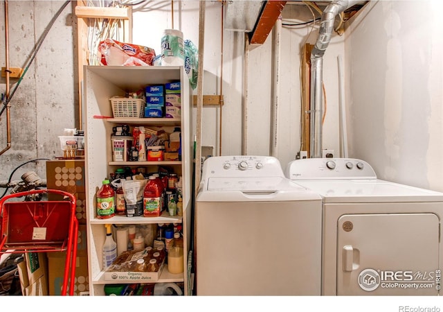 clothes washing area with washing machine and dryer