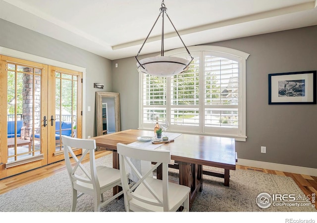 dining space featuring hardwood / wood-style flooring and french doors