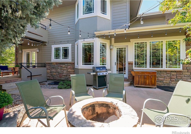 view of patio featuring area for grilling and an outdoor fire pit