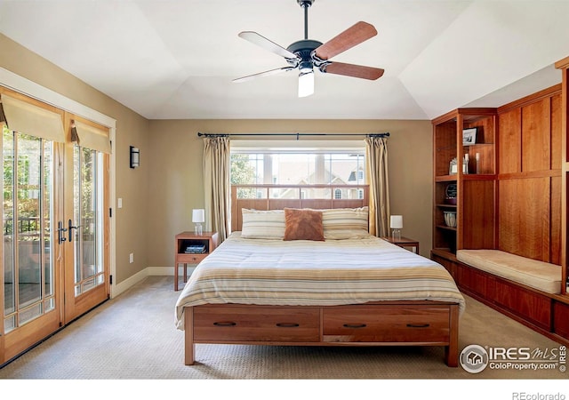 carpeted bedroom featuring ceiling fan, lofted ceiling, access to exterior, and multiple windows