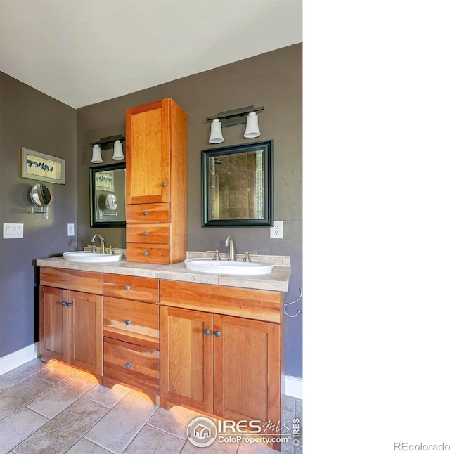 bathroom with tile patterned floors and vanity