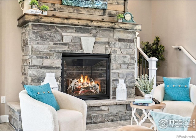 interior space featuring wood-type flooring and a stone fireplace