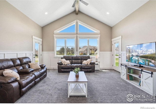 carpeted living room with vaulted ceiling with beams