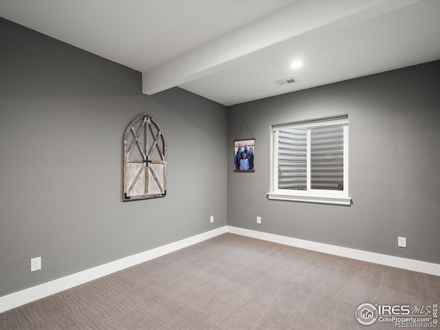 empty room with beam ceiling and carpet floors