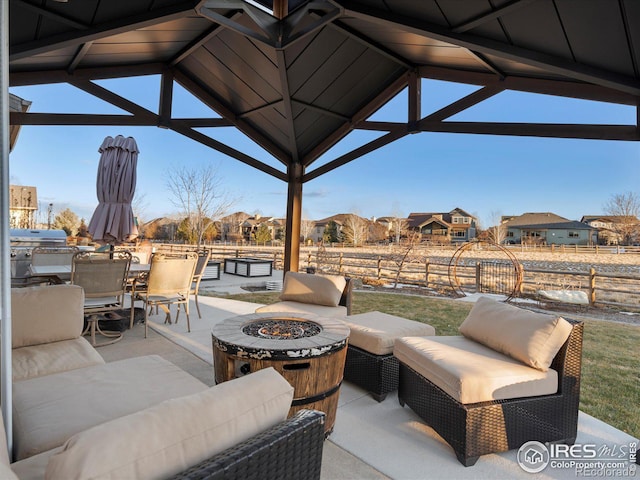 view of patio featuring a gazebo, grilling area, and an outdoor fire pit