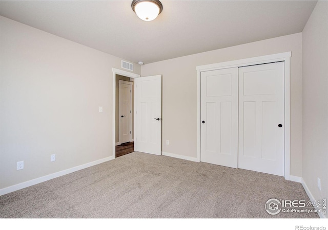 unfurnished bedroom featuring carpet floors and a closet